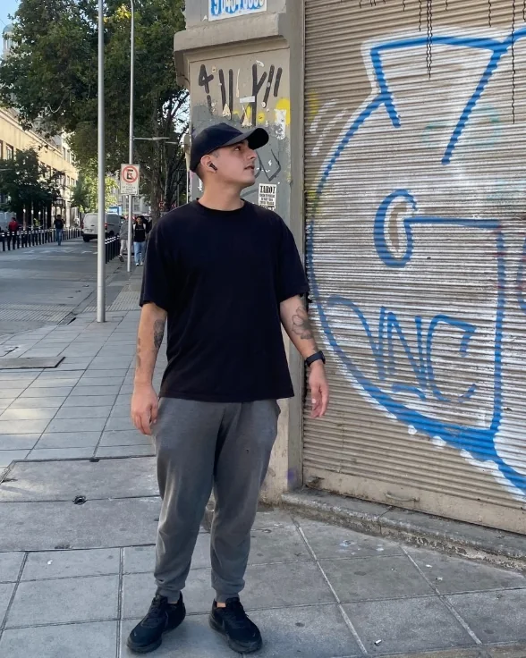 Mateo Plaza junto a una pared con grafiti